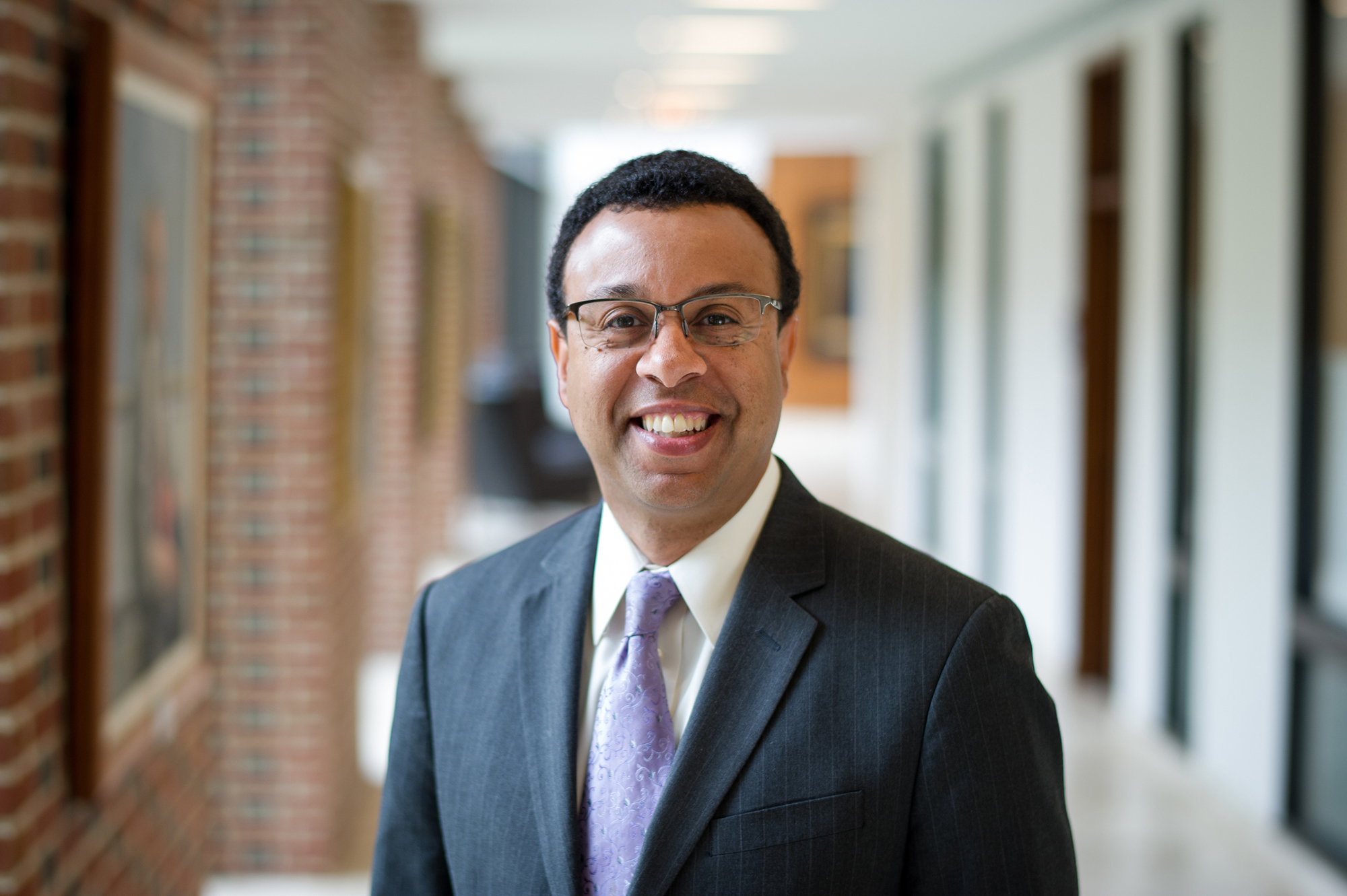 Interim President Pritchett poses in the hallway at the Carey Law School