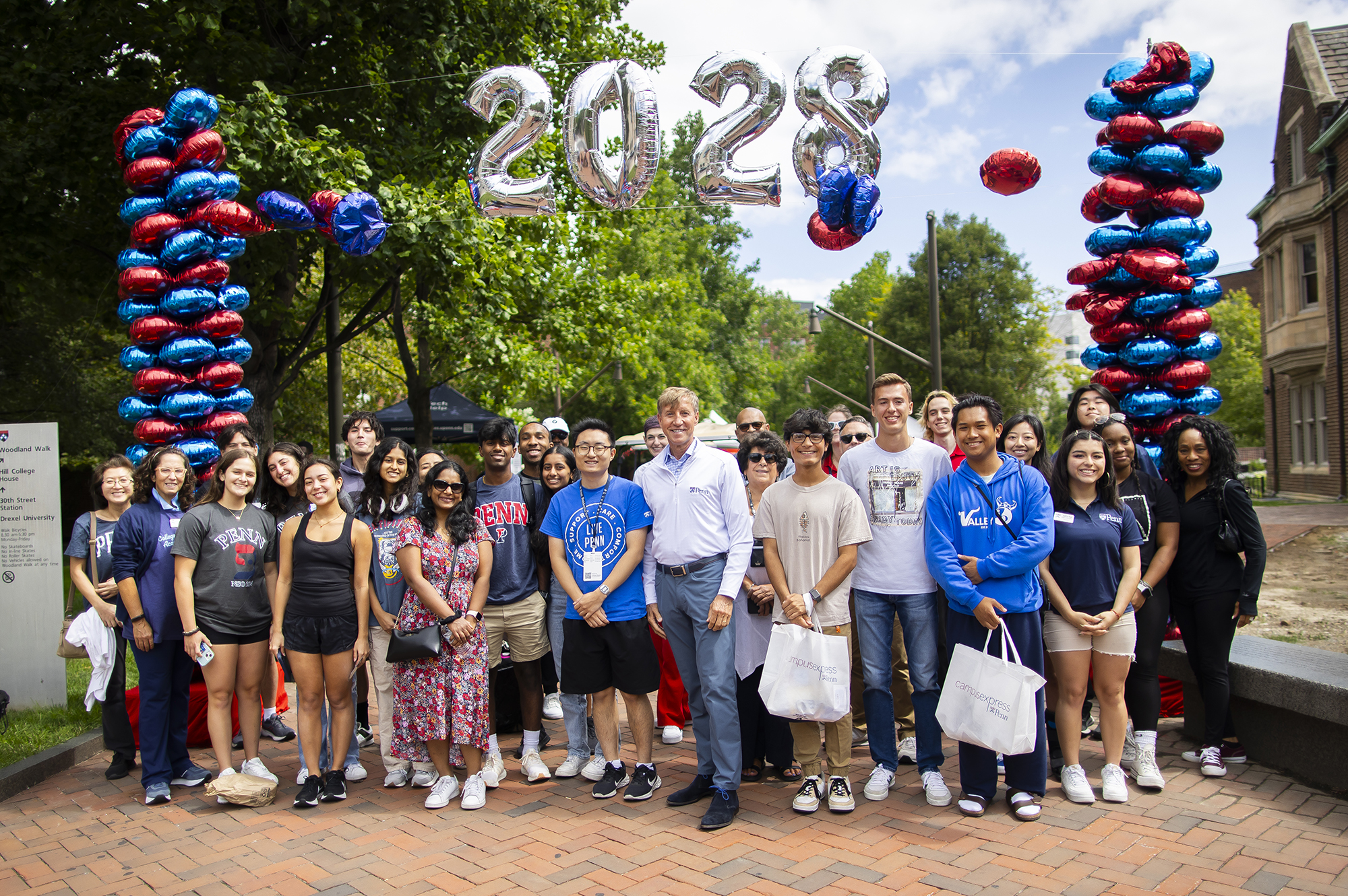 some members of the class of 2028 standing with Interim President J. Larry Jameson under move-In 2024 celebration balloons